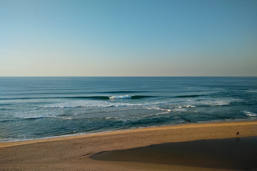 Few surfers enjoying perfect conditions at Praia de Santa Rita