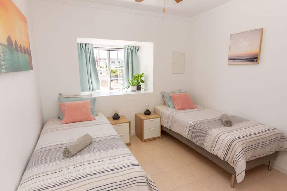 Twin beds in a room with private bathroom