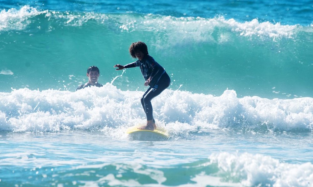 Beginner surfer in action during the surf lesson