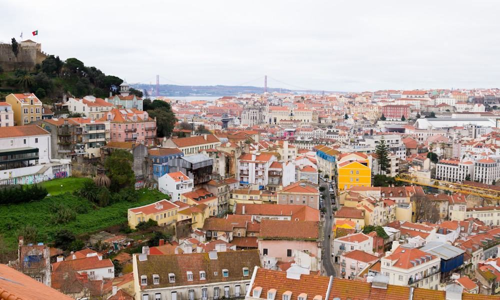 View over the city of Lisbon with in the background the Tagus river and Ponte 25 de Abril bridge