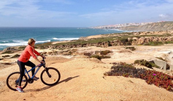 Mountain biking on the coastline with Ericeira in the background